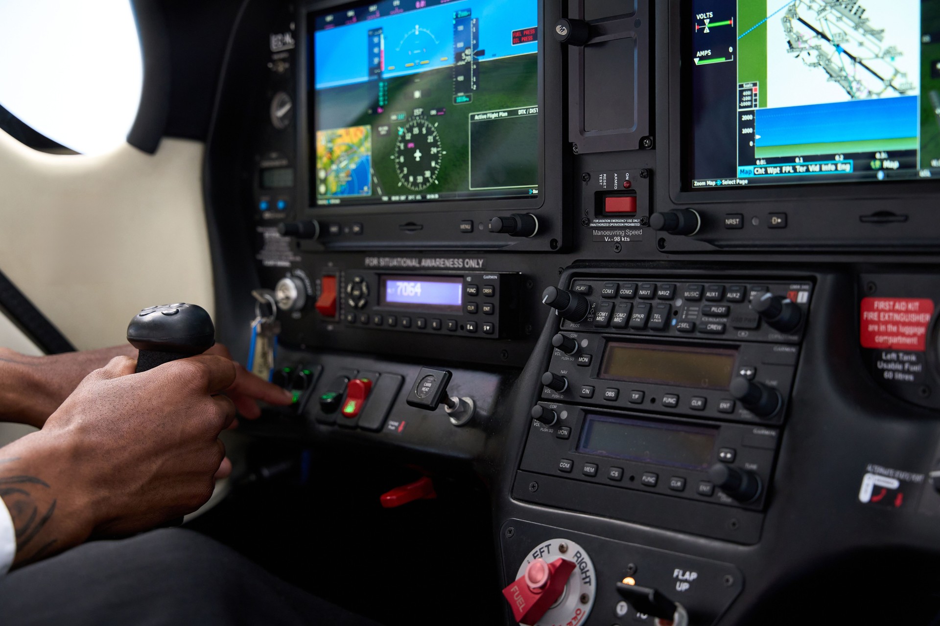 Pilot operating aircraft flight simulator cockpit control panel